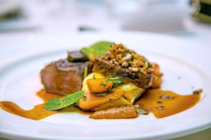 freshly prepared beef with potatoes and sauce, plated up nicely for a visitor to the lensbury conference centre in Teddington