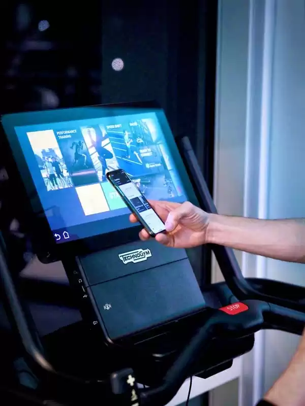 A arm holding a phone reaches out in front of the Techno Gym equipment which is available to use at the Lensbury gym in Teddington. The health and fitness centre is open 6:00-22:00 Monday to Thursday, 6:00-21:00 Friday and 7:00-20:00 on weekends.