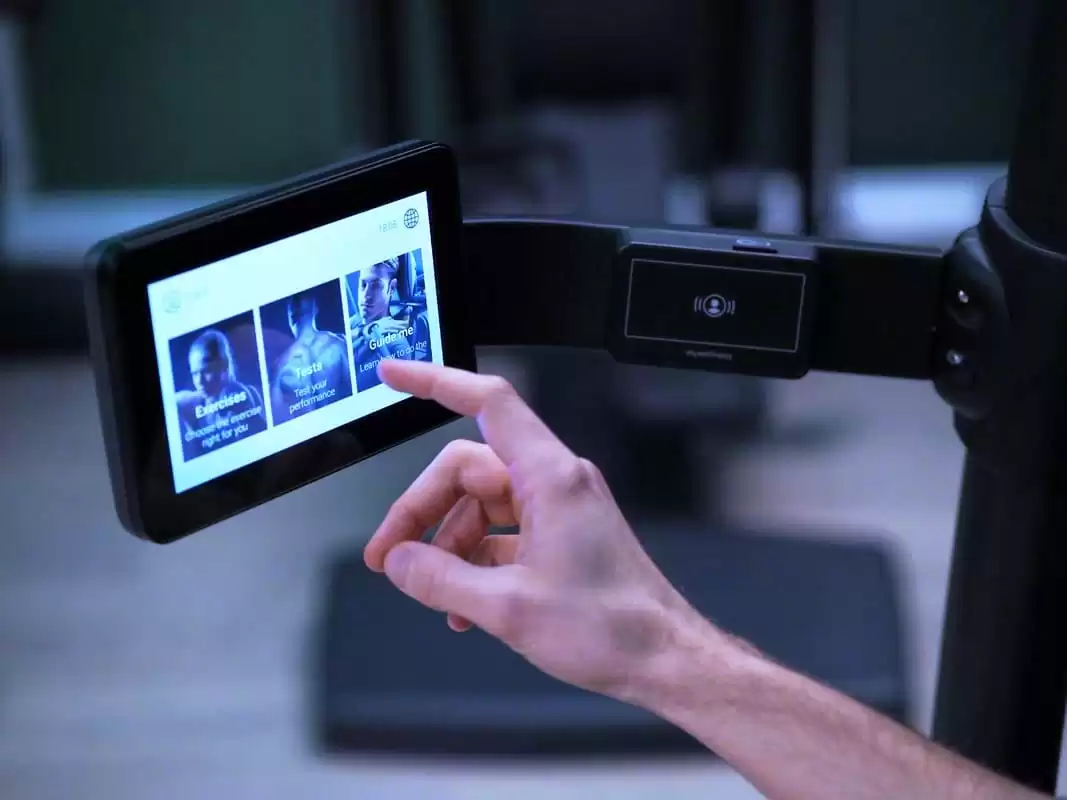 a hand reaches out to touch the screen of the Techno Gym equipment which is available to use at the Lensbury gym in Teddington. The health and fitness centre is open 6:00-22:00 Monday to Thursday, 6:00-21:00 Friday and 7:00-20:00 on weekends.