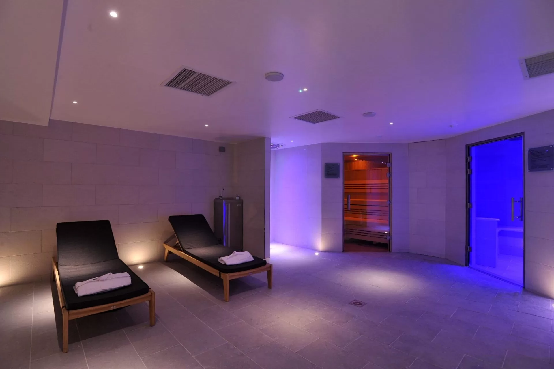Thermal suite with 2 lounge chairs and sauna at The Lensbury Club fitness centre & gym in Teddington.