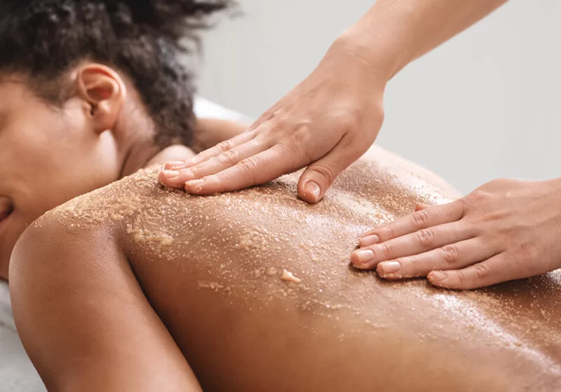 Woman receiving a back massage at The Lensbury Spa