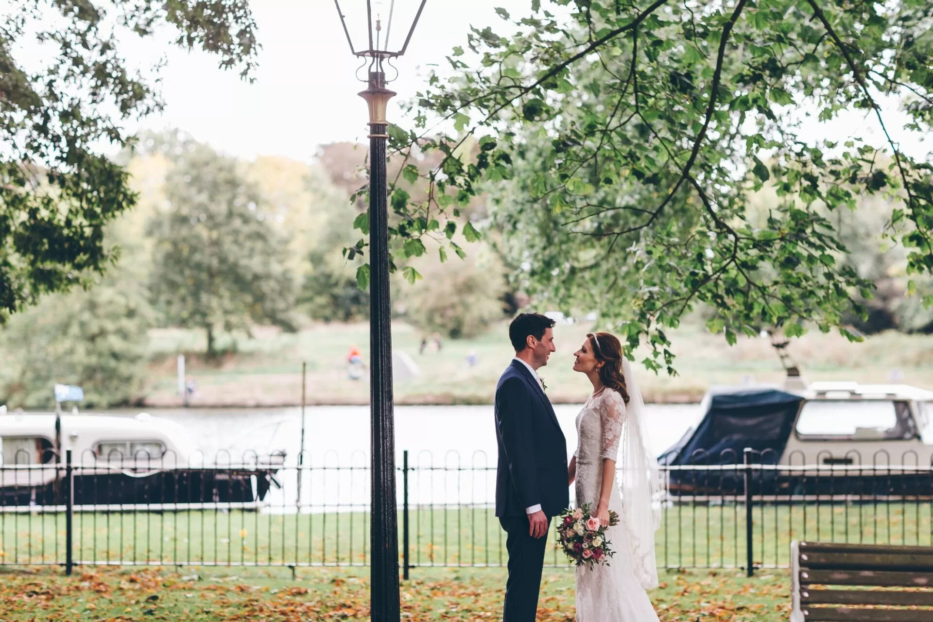 Married couple under lamppost by the River Thames in Teddington a wedding and reception venue near me