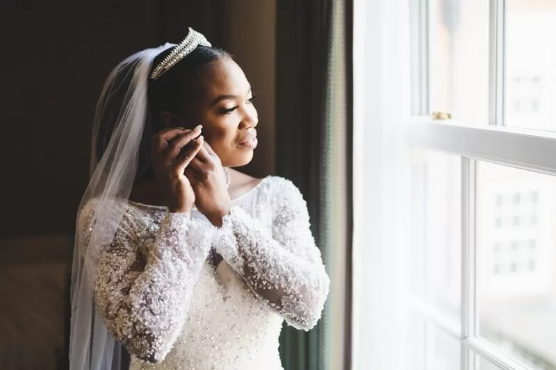 Bride on her wedding day looking out of window at The Lensbury in Teddington London, provider of riverside wedding and reception package venue near me
