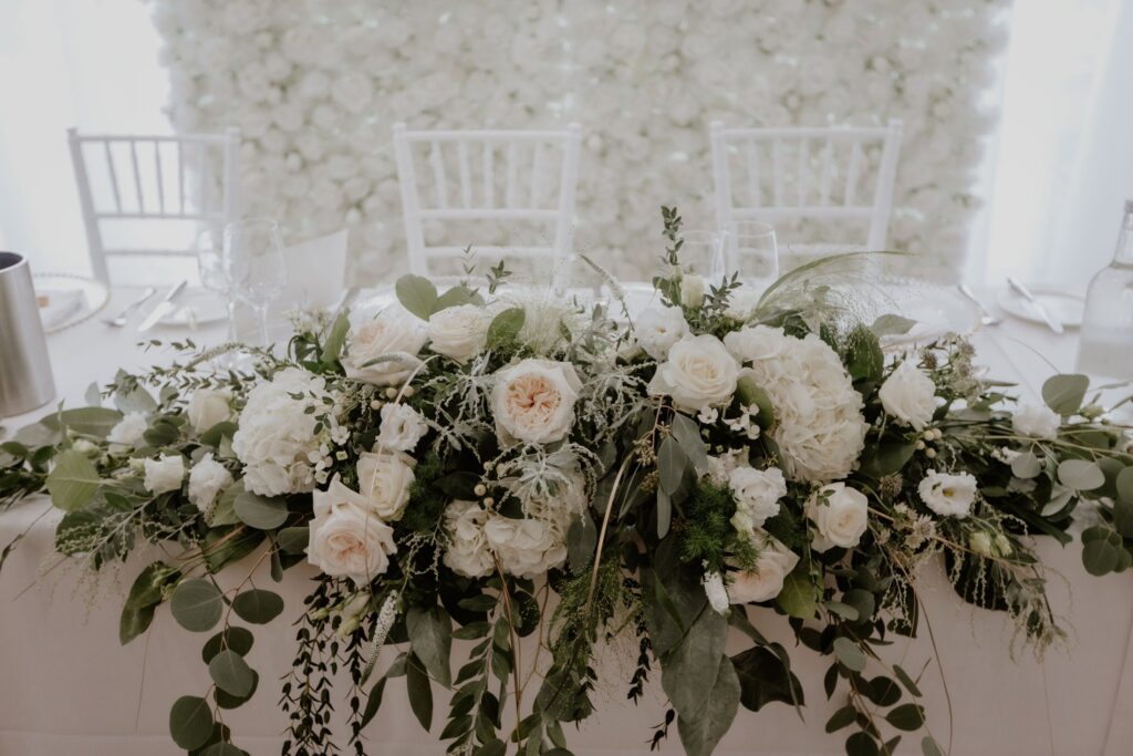 White wedding bouquet on table at The Lensbury a riverside wedding and reception package venue near me