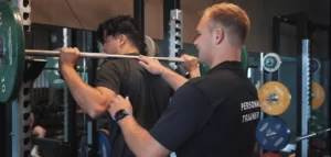 Man using squat rack at The Lensbury Gym