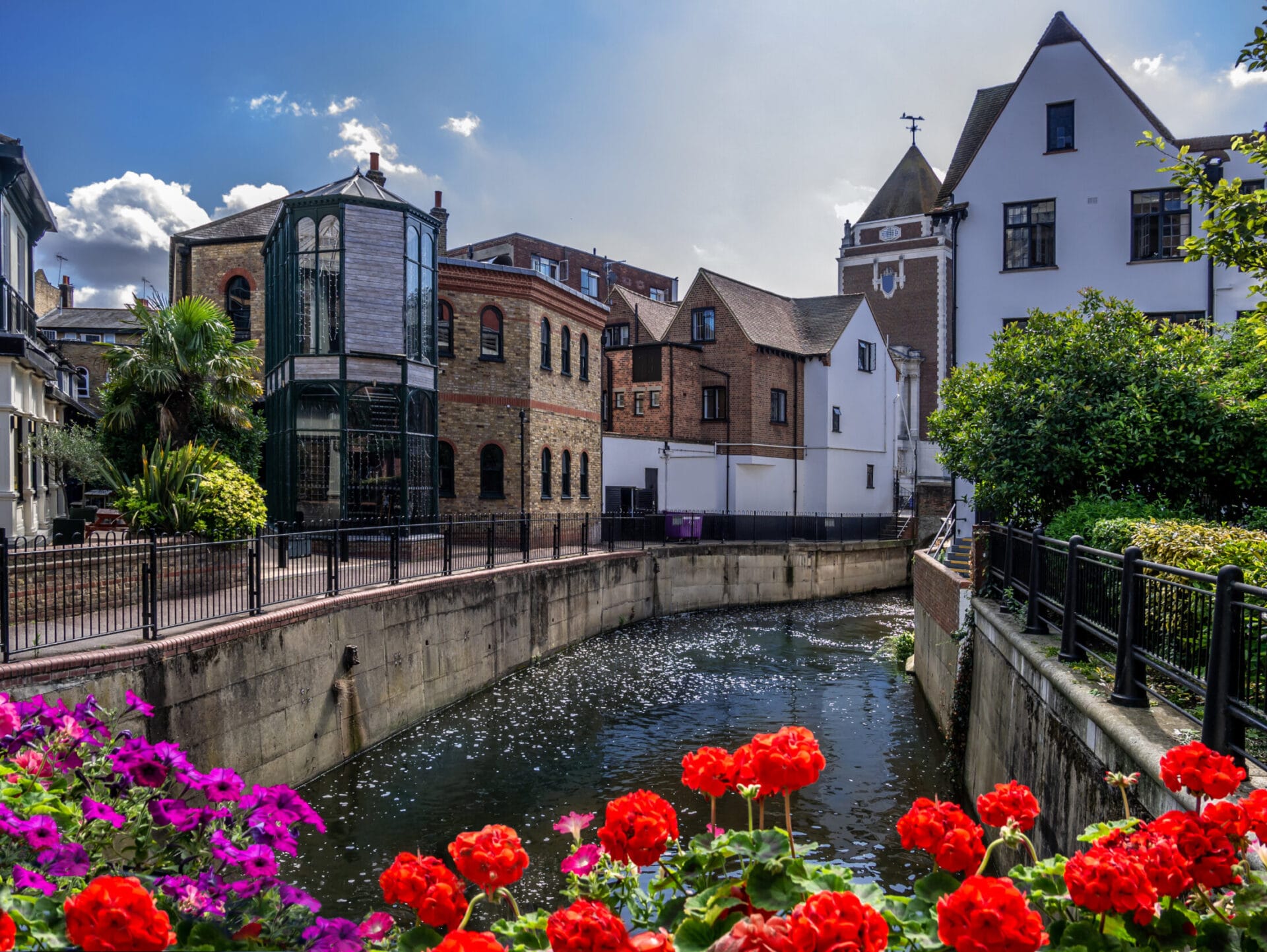 Beautiful summer scene in Kingston upon Thames with canal water among traditional English houses in a sunny day